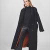 model with black coat and orange linen